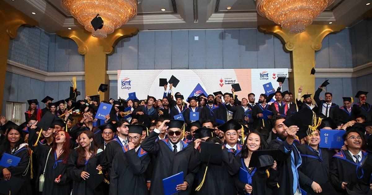 Students studying at a distance MBA college in Mumbai with laptops and books